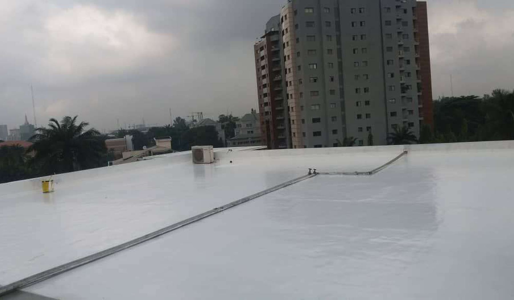 Reflective waterproof membrane laid across a large roof deck